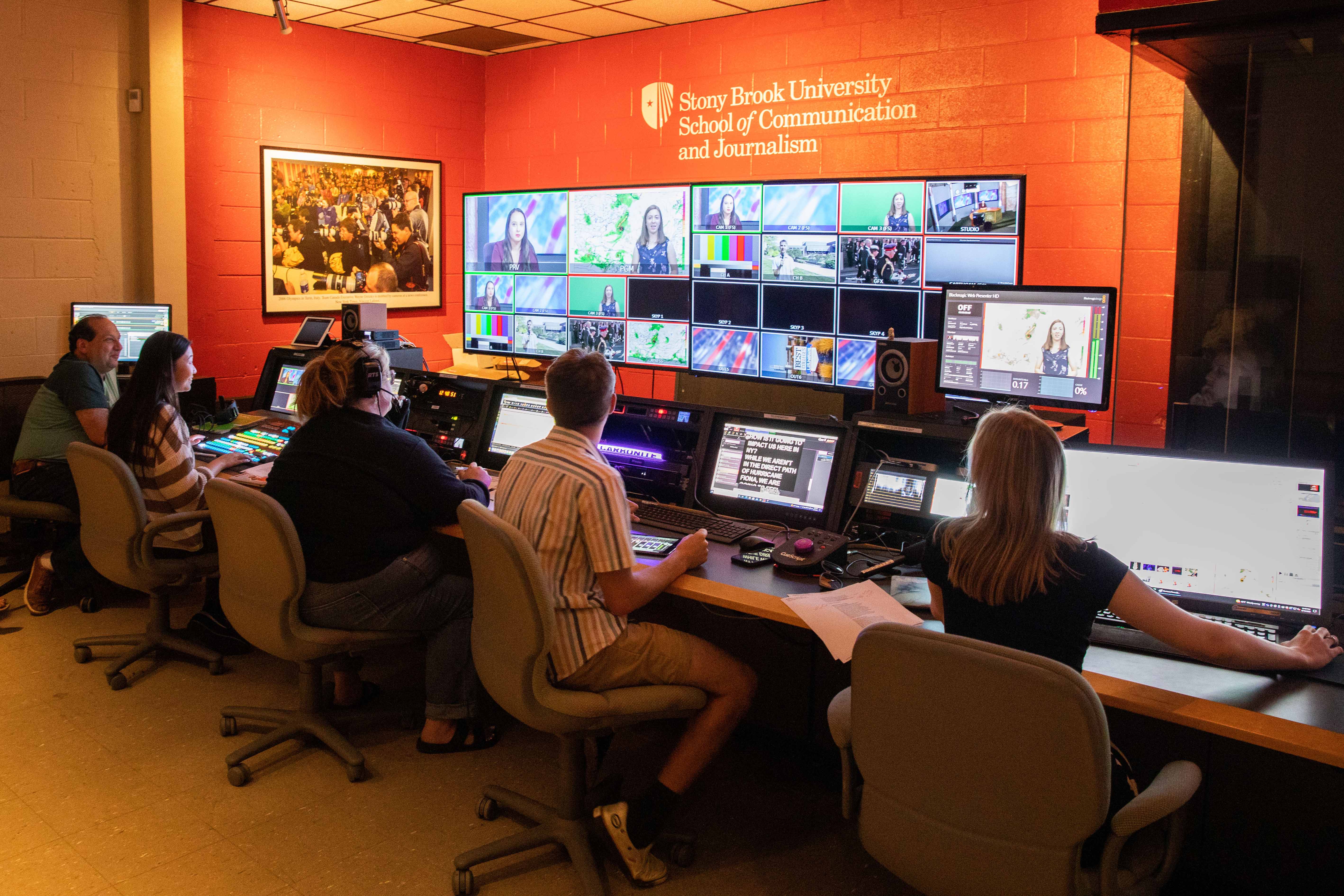 students sit at computers in the production studio control room