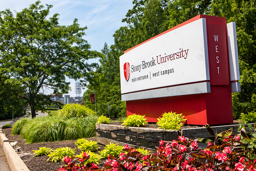 Front welcome sign to the University; flowers